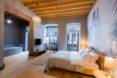 a bedroom with a bed and a living room at Art Pera Suites in Istanbul