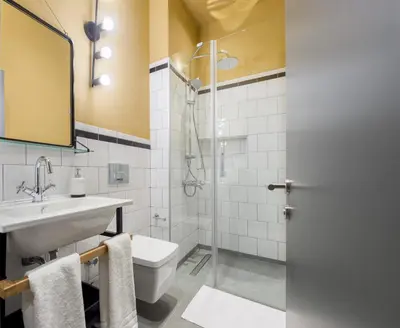 a bathroom with a sink and a toilet and a shower at Art Pera Suites in Istanbul