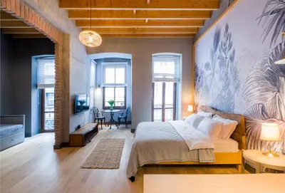 a bedroom with a large bed and a living room at Art Pera Suites in Istanbul