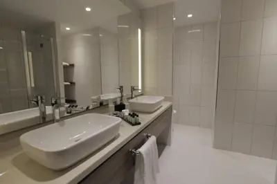 a bathroom with two sinks and a large mirror at Tuyap Palas in Istanbul