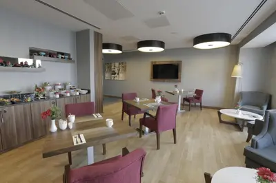 a dining room with tables and purple chairs at Tuyap Palas in Istanbul