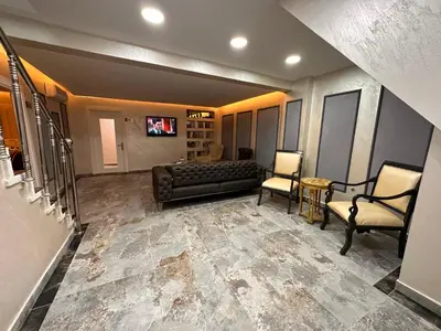 a living room with a couch and two chairs at HARRAN HOTEL in Istanbul