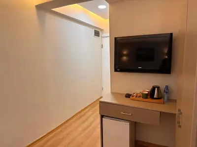 a room with a flat screen tv on a wall at HARRAN HOTEL in Istanbul