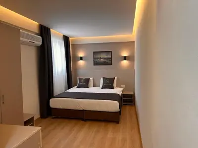 a small bedroom with a bed in a room at HARRAN HOTEL in Istanbul