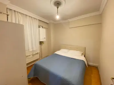 a bedroom with a blue bed and a window at 2 bedrooms central area located appartment 2 floor in Istanbul
