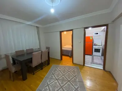 a dining room with a table and a kitchen at 2 bedrooms central area located appartment 2 floor in Istanbul