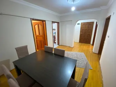 a dining room with a black table and chairs at 2 bedrooms central area located appartment 2 floor in Istanbul