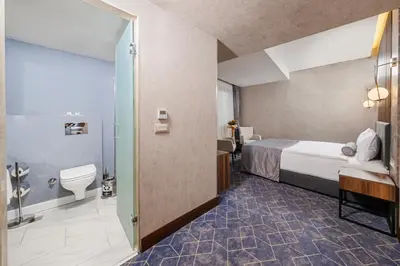 a hotel room with a bed and a bathroom at Ring Stone Hotels Bosphorus - Special Class in Istanbul
