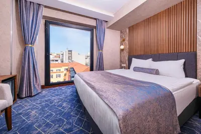 a hotel room with a bed and a large window at Ring Stone Hotels Bosphorus - Special Class in Istanbul