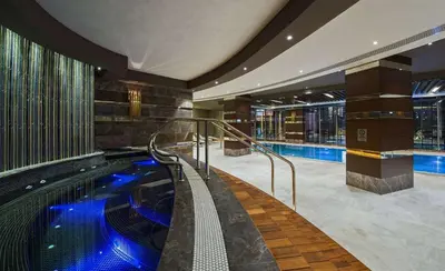 a large swimming pool in a hotel with a swimming pool at Hilton Istanbul Kozyatagi in Istanbul