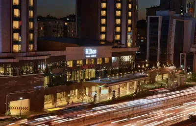 a building at night with traffic in front of it at Hilton Istanbul Kozyatagi in Istanbul