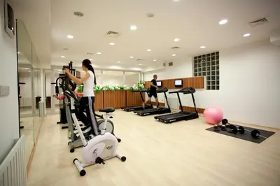 a woman taking a picture of a gym at Sefa Hotel 2 Çorlu in Corlu