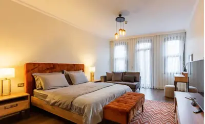 a bedroom with a bed and a chair and a couch at Taksim 360 Luxe Apartment Prime Istanbul Location in Istanbul