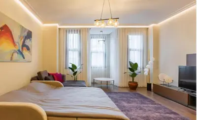 a bedroom with a bed and a living room at Taksim 360 Luxe Apartment Prime Istanbul Location in Istanbul