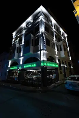 a building with lights on the side of it at night at Costera Hotel in Istanbul