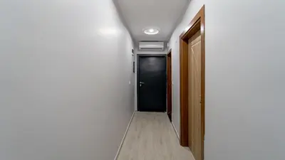 a hallway with a black door in a room at KUMBAĞ ŞEHRİ SARAY APART OTEL in Tekirdag