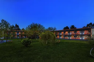 a building with a grass field in front of it at KİRAZ BEACH OTEL in Erdek