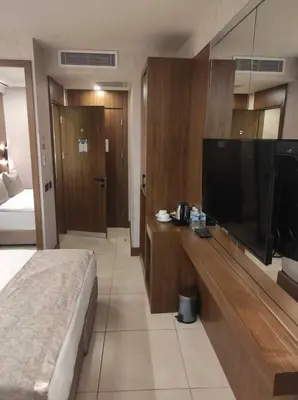a bedroom with a large flat screen tv and a bed at Four Sides Beyoglu in Istanbul