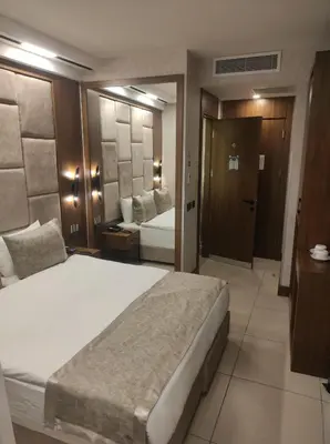 a bedroom with a large white bed in a room at Four Sides Beyoglu in Istanbul