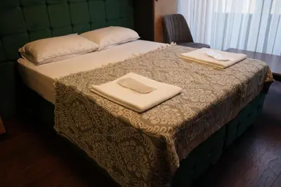 a bed with two towels on top of it at Middle Village in Istanbul
