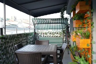 a table and chairs on a balcony with plants at Middle Village in Istanbul