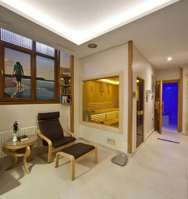 a living room with a chair and a table at GLK PREMIER Acropol Suites & Spa in Istanbul