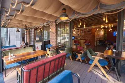 a restaurant with benches and tables and chairs at Sunlight Hotel in Istanbul