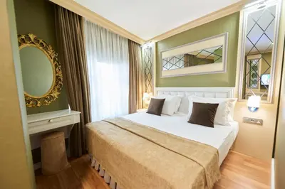a bedroom with a bed and a mirror at Sunlight Hotel in Istanbul