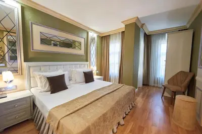 a bedroom with a large bed and a chair at Sunlight Hotel in Istanbul