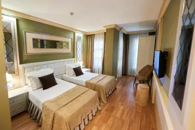a hotel room with two beds and a flat screen tv at Sunlight Hotel in Istanbul