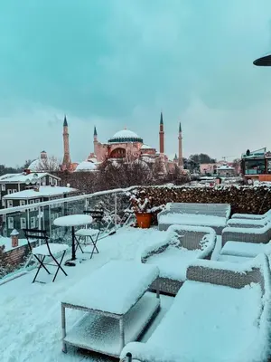 a snow covered rooftop with tables and chairs at Armagrandi Spina Hotel-Special Category in Istanbul