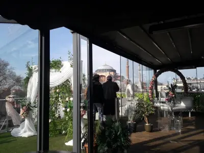 a group of people standing in a pavilion at a wedding at Armagrandi Spina Hotel-Special Category in Istanbul