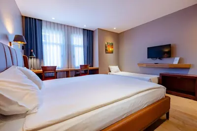 a hotel room with a large bed and a television at Armagrandi Spina Hotel-Special Category in Istanbul