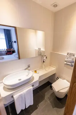 a bathroom with a sink and a toilet and a mirror at Armagrandi Spina Hotel-Special Category in Istanbul