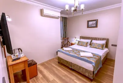 a hotel room with a bed and a desk at Hotel Saba in Istanbul