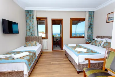 a hotel room with two beds and a television at Hotel Saba in Istanbul