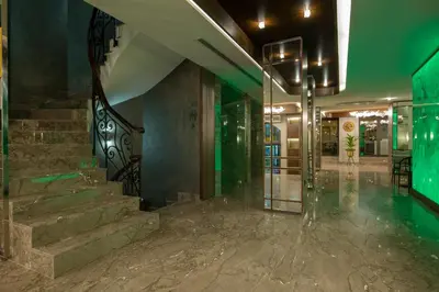 a lobby with stairs and a green wall at Hotel Nena Sultanahmet in Istanbul