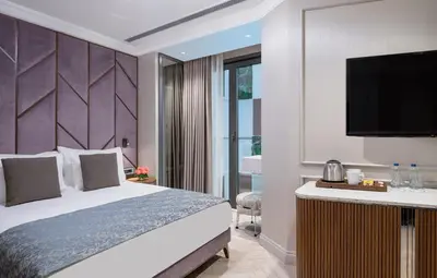 a hotel room with a bed and a flat screen tv at Hotel Nena Sultanahmet in Istanbul