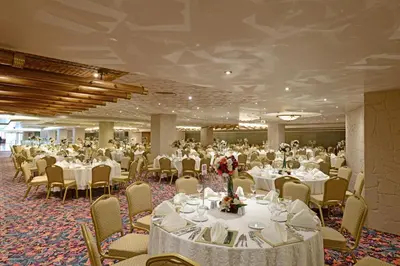 a banquet hall with white tables and chairs at Eresin Hotels Topkapı in Istanbul