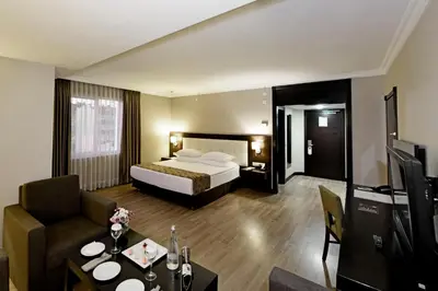 a hotel room with a bed and a living room at Eresin Hotels Topkapı in Istanbul