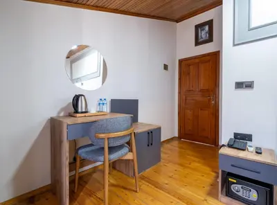 a room with a desk with a chair and a television at Sur Hotel Sultanahmet in Istanbul
