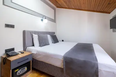a bedroom with a large bed and a night stand at Sur Hotel Sultanahmet in Istanbul
