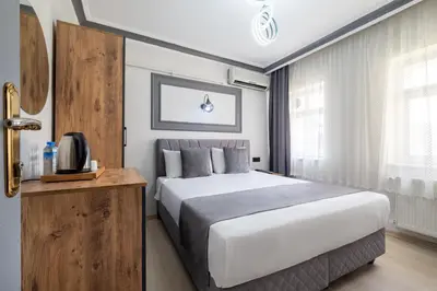 a bedroom with a large white bed in a room at Sur Hotel Sultanahmet in Istanbul