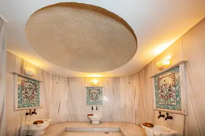 a bathroom with two toilets and a large ceiling at Hotel Yasmak Sultan in Istanbul