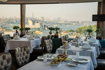 a restaurant with tables and chairs with a view of the city at Hotel Yasmak Sultan in Istanbul