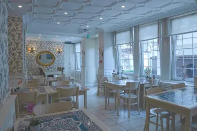 a restaurant with tables and chairs and windows at Avicenna Hotel Sultanahmet in Istanbul