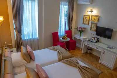 a hotel room with two beds and a television at Avicenna Hotel Sultanahmet in Istanbul
