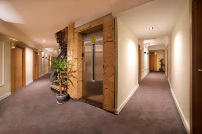 a hallway of an office building with a brick wall at Barin Hotel in Istanbul