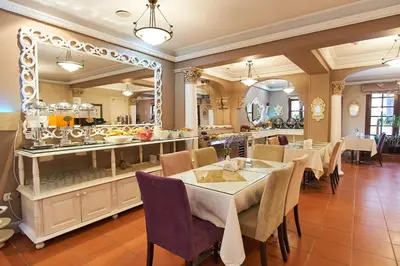 a dining room with a table and a large mirror at Celal Sultan Hotel Special Class in Istanbul
