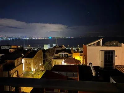a view of a city at night with the water at Hanedan Hotel in Istanbul